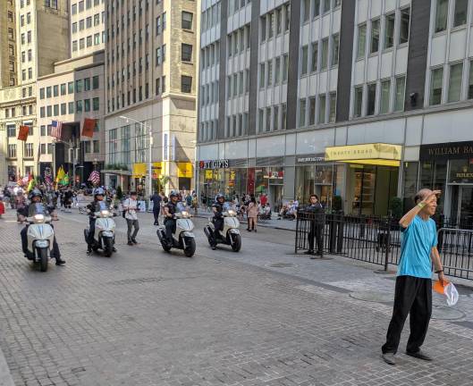 Motorcycle cops of Patrol Borough Manhattan South come upon a Broad Street tourist.