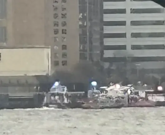 The scene where a sightseeing helicopter, attempting to return to the Skyport heliport near Wall Street, lost power and crashed upside down into the Hudson River, off of Hoboken, NJ, killing all six people on board.