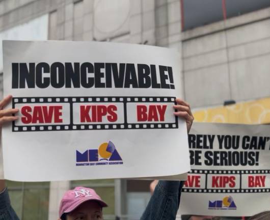 Protestors held signs and chanted “Save our theater!” outside of the Kips Bay AMC 15 in protest of its planned closure at the end of the year.