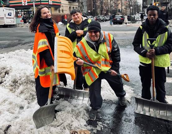 The work crew on Feb. 25 shoveling snow on the Upper East Side. Our intrepid reporter Heather Stein (left) was one of the few women on the job.