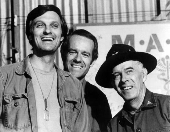 “M*A*S*H” cast members for 1975 (left to right): Alan Alda, Mike Farrell and Harry Morgan. Photo: CBS Television, via Wikimedia Commons