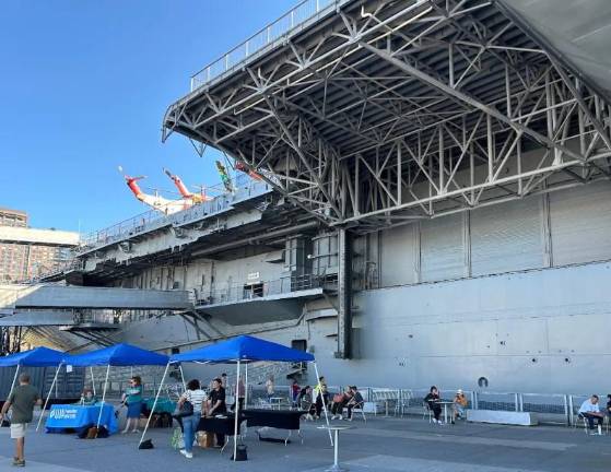 Volunteers check in on the flight deck of the<i> Intrepid</i>.