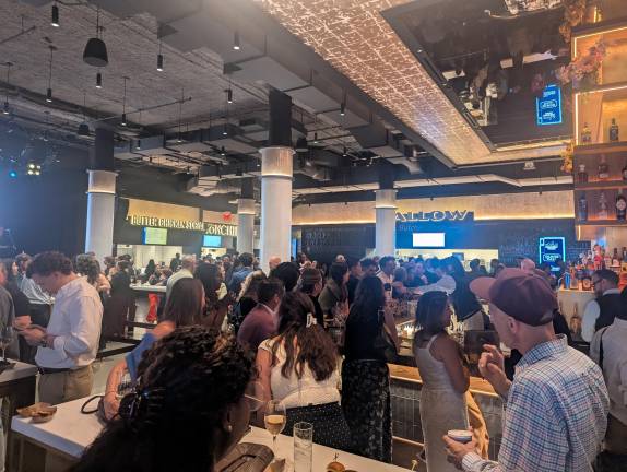 Guests gather around Shaver Hall bar and food vendors.