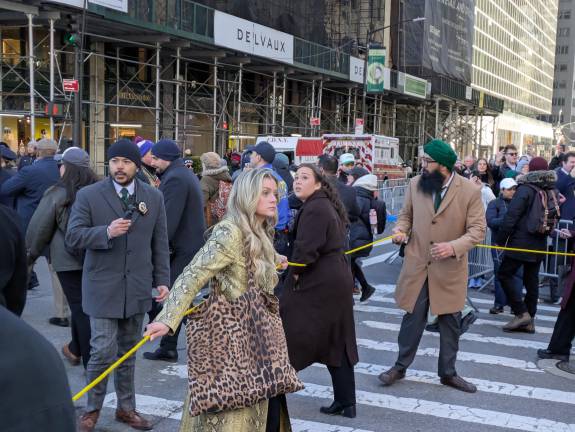 Mayoral staff members holding the yellow cordon of inaccessabilty, a marked changed from Mayor Adams protocol, which allowed closer access.