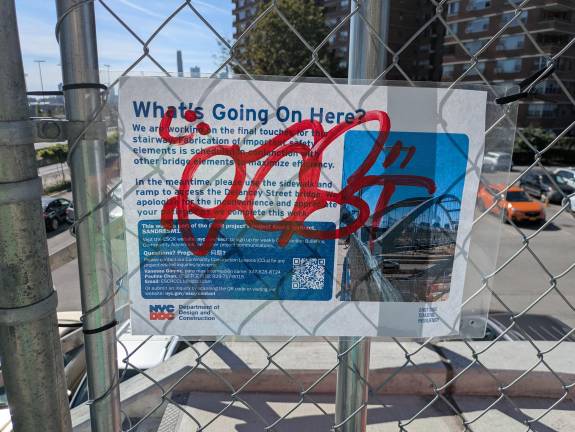 Department of Design and Construction sign about the Delancey Street Bridge staircase.