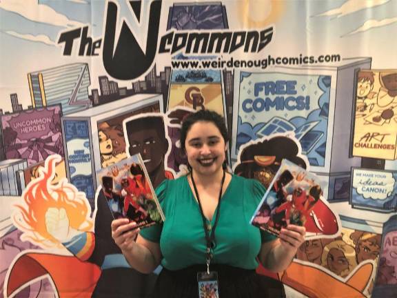 Joamette Gil holding her comic book, The UnCommons.