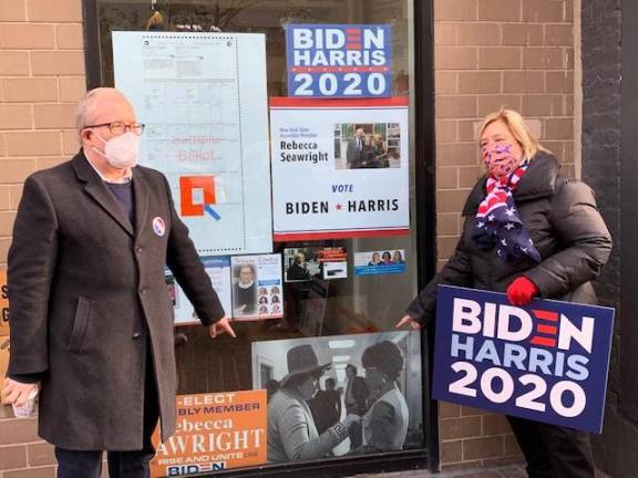 Assembly Member Rebecca Seawright campaigns with city Comptroller Scott Stringer outside headquarters on First Avenue. Stringer is pointing to a photo of his aunt, Rep. Bella Abzug. Seawright is pointing to Rep. Shirley Chisholm. Photo courtesy of Seawright campaign