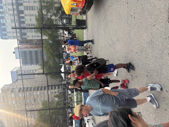 Downtown, the biggest draw at the 13th Precinct’s National Night Out on East 20th Street was the charcoal-broiled hamburgers that police were grilling. The main event took place in the Peter’s Field playground.