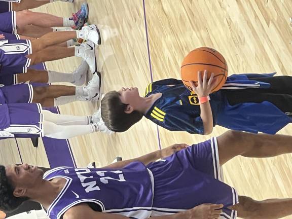 Ready for the season: A young NYU Violets fan gets ready for some buckets action.