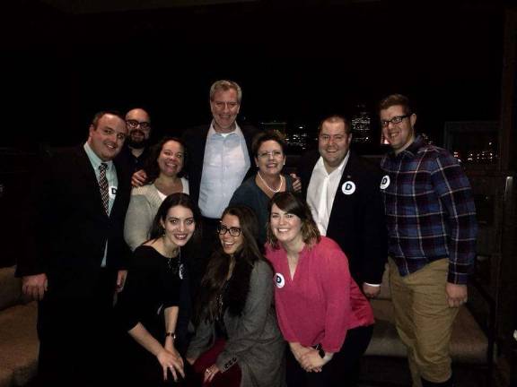 Mayor Bill de Blasio poses with Polk County Democratic Party activists on the sixth-floor outdoor terrace of Republic on Grand, a Des Moines hotel bar, after his speech to the liberal advocacy group Progress Iowa on December 19th. County Chair Sean Bagniewski (second from right) is viewed as an influential local powerbroker. Photo: Polk County Democratic Party