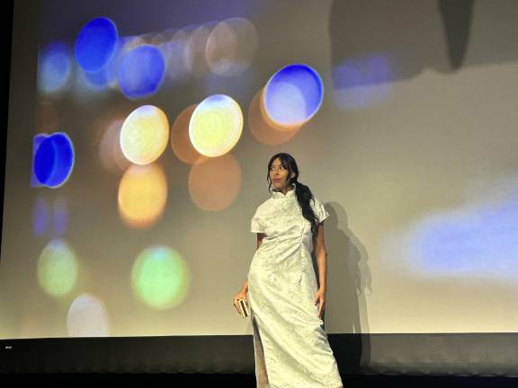 Ana Jimenez wears an white dress for the city nightlife segment of the show.