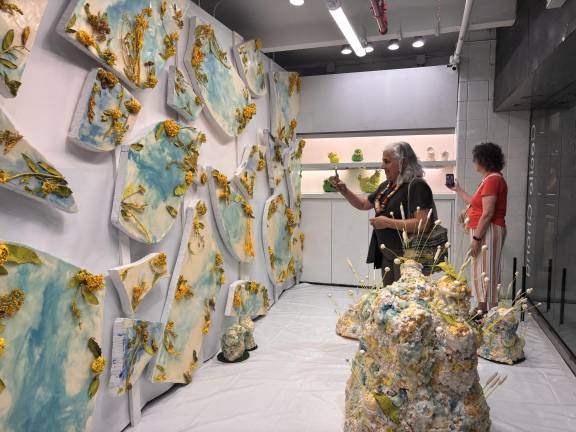 Visitors explore Cecile Chong’s <i>Chicken Little – Líneas de Falla / Fault Lines</i> at Whitebox Portable in the Times Square transit hub.
