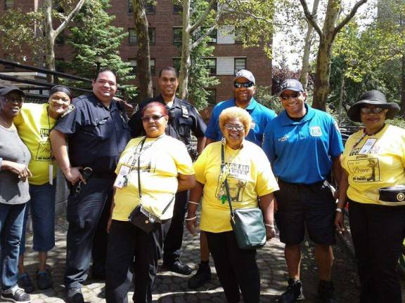 Carmen Quinones (first row at right) with tenants and cops at the Frederick Douglass Houses in Manhattan Valley, where she helms the tenants association. Photo courtesy of Carmen Quinones