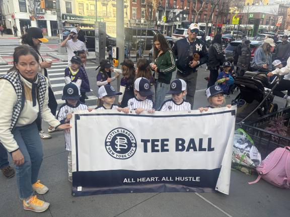 Tee ballers, barely bigger than the banner, get ready to step off at the start of the Opening Day parade for the Peter Stuyvesant Little League. There are still Tee ball openings for players living in the district between East 12th Street and East 72nd Street.