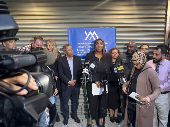Letitia James was among the many elected officials who joined neighborhood residents at a candleight vigil outside Sal’s Deli &amp; Grocery. Dr. Debbie Almostaser, a vice president of the Yemeni American Merchants Association (foreground with head scarf) was one of the organizers.