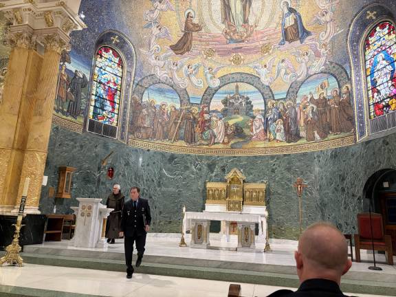 Retired firefighter Dennis Burke leaving the podium at St. Francis of Assisi after briefly speaking.