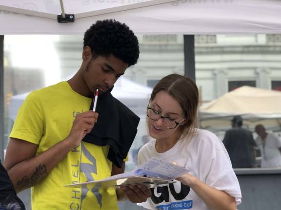 A voter registration drive on 116th Street in Harlem focused on the 35,000 parolees in New York state who are newly eligible to vote as a result of an executive order issued in April by Gov. Andrew Cuomo. Photo: Emily Barnard/Getting Out and Staying Out