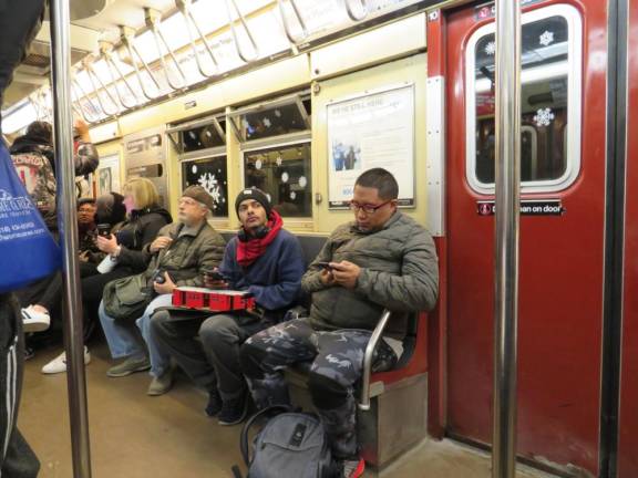 One subway enthusiast held his Lego Model of the exact red car that he was riding in. Photo: Ralph Spielman