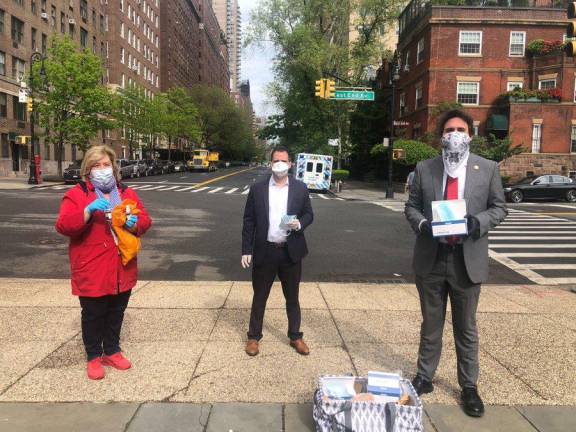 On Friday, May 15, Assembly Members Rebecca Seawright and Dan Quart (left to right) and Council Ben Kallos gave out face masks and hand sanitizer at Carl Schurz Park.