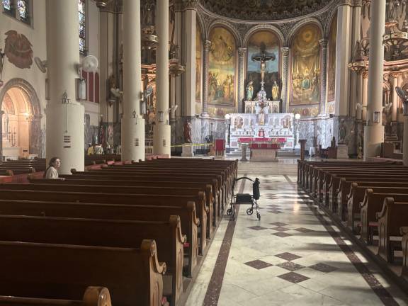 A lone worshipper was inside Most Holy Redeemer Church on the morning of Aug. 29 in what could be the last days the church will be open. The Archdiocese announced that there will be no more Sunday Masses at the church after Sept. 1.