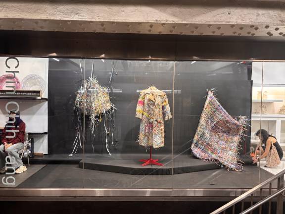 Works by Chin-Chih Yang are displayed behind the glass storefront of Whitebox Portable, a gallery located inside the Times Square subway complex.