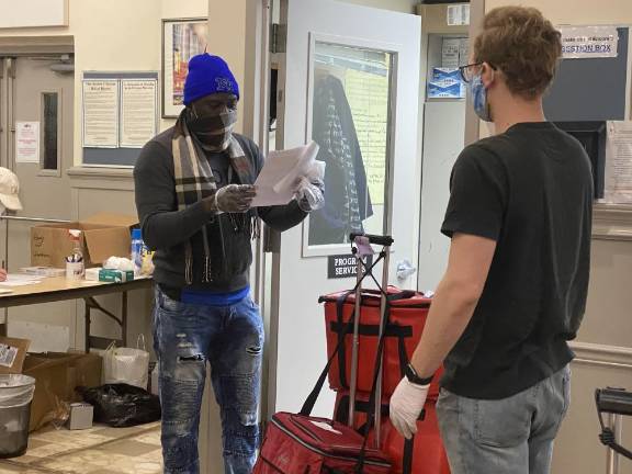 A volunteer gets ready to go on a Citymeals delivery.