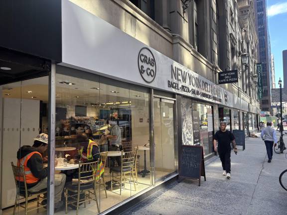 Despite the chaos that surrounded the Roosevelt Hotel at the peak of the migrant crisis, some of the businesses on the ground floor of the Madison Avenue-facing side seemed to be surviving. Here two workers grab a mid-morning coffee at the New York Deli, Cafe &amp; Pizza.