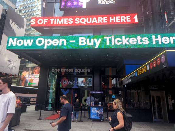 One Times Square entry. Tickers advertising exhibitions and skywalk.