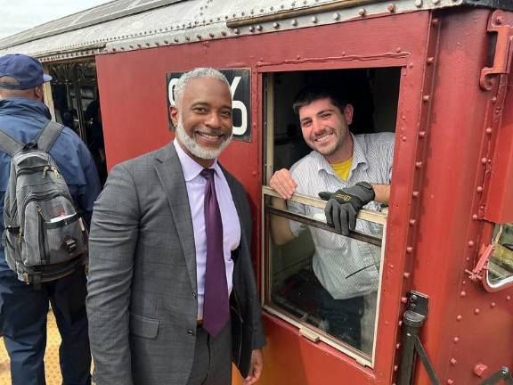 NYC Transit President Demetrius Crichlow (left) with a delighted Redbird train conductor on the first-ever Mets Opening Day nostalgia train to Citi Field. It departed from the Hudson Yards station on April 4.