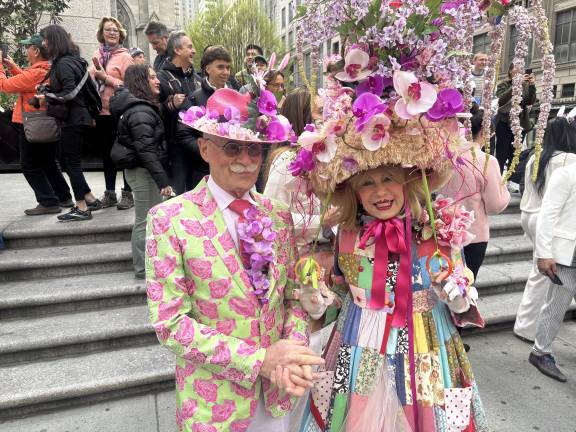 Howard Chezar and Patricia Fox, from the Upper West Side, join the promenade on Fifth Avenue on April 20. Fox said she used an upside-down dog bed as the foundation for her hat.
