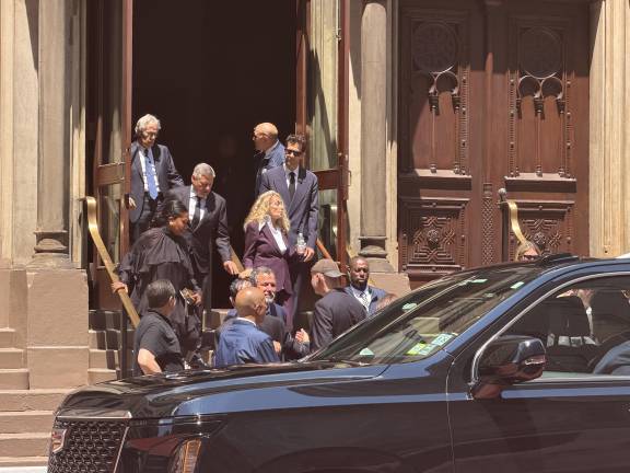 Netflix CEO Ted Sarandos (wearing a black suit) and his wife (wearing a black dress) were among the last to leave the ceremony.