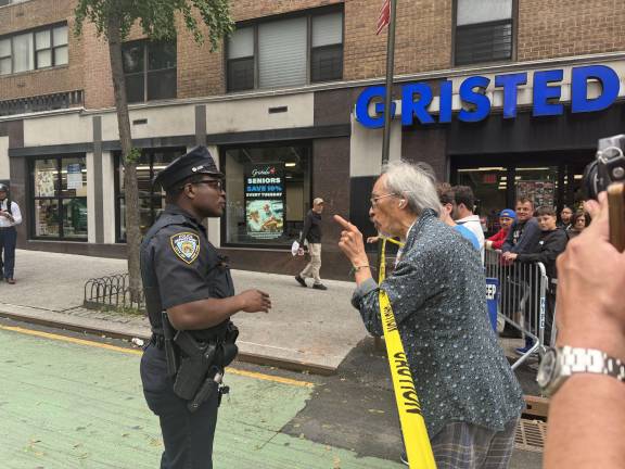 A resident of the frozen zone in a dispute with an NYPD officer after being told he cannot return home.