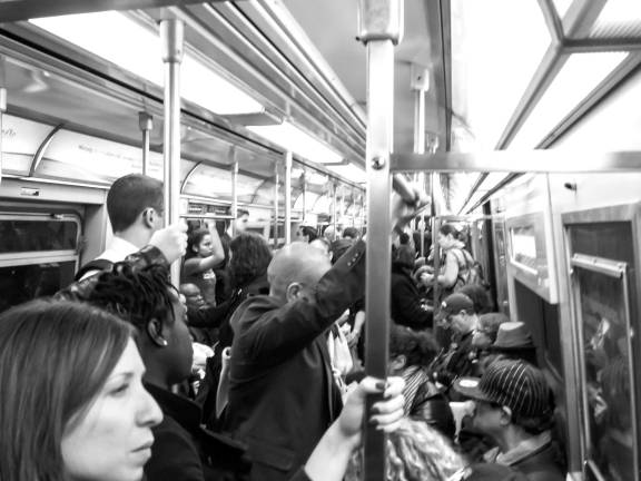 NYC Commandment 2C: Consider as urban yoga the pretzel-like positions you assume in order to fit onto busy trains. Photo: Susan Sermoneta, via flickr