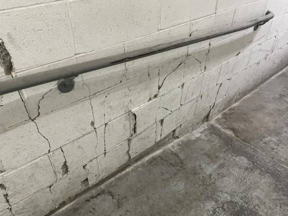 In the past week, new cracks have appeared in the cinder blocks of the Chung Pak wall bordering the Chinatown jail demolition site. Some blocks have shifted out of place.