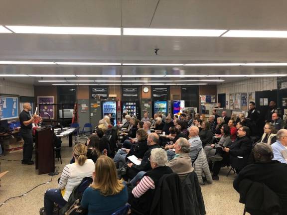 A recent community meeting at the 20th Precinct.