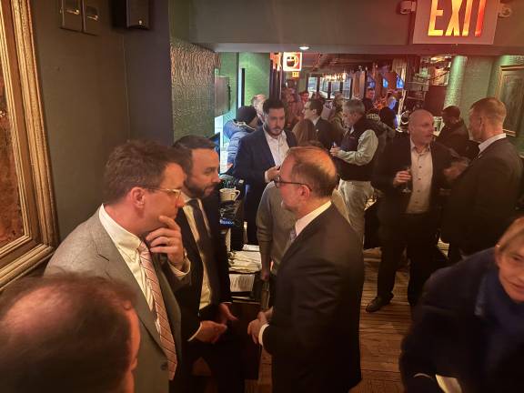 Keith Powers hob knobs with new City Comptroller Mark Levine (center) at his victory party.