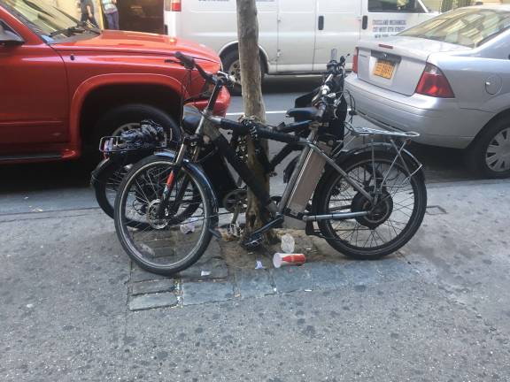 Mayor Bill de Blasio announced plans last week to fine business that employ deliver workers who ride motorized bicycles such as these.