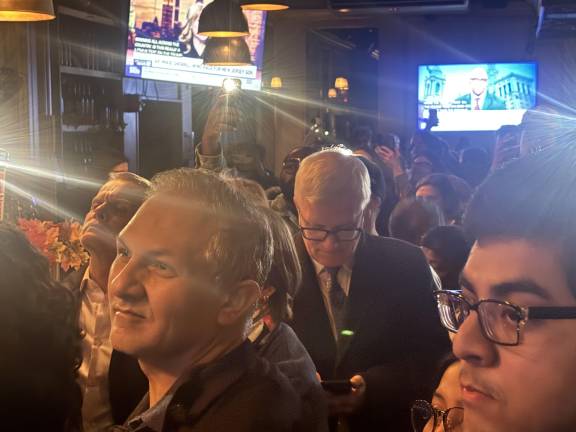 Local elected officials, such as NYS Senator Brian Kavanagh (center, checking his cellphone), were making the rounds. Here Kavanagh stopped by Harvey Epstein’s watch party.
