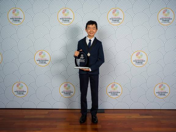 Miles Wu, 14, of Hunter College High School, holding his ASCEND Award—the top prize at the Thermo Fisher Scientific Junior Innovators Challenge, the nation’s leading middle-school STEM competition.