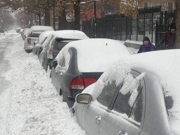 Cars blanketed in snow on E. 10th St. in the East Village on Jan. 25.