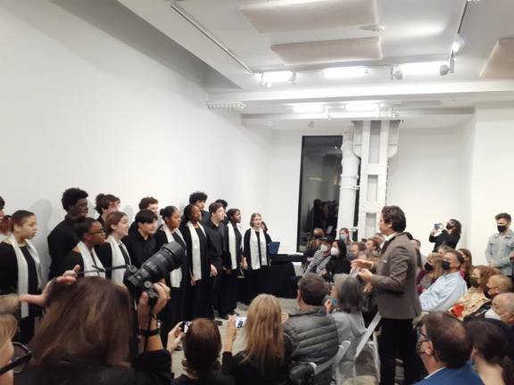 Founder and artistic director Francisco J. Núñez lead the Young People’s Chorus of NYC in a performance at the AloneTogether exhibit preview in Chelsea. Photo: Karen Camela Watson