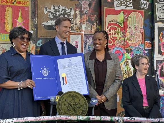 Left to right, Jeanine Heriveaux, Erik Bottcher, and Lisane Basquiat. Heriveaux holds the proclamation that announces the co-naming of the block on Great Jones Street between Bowery and Lafayette as “Jean-Michel Basquiat Way.”