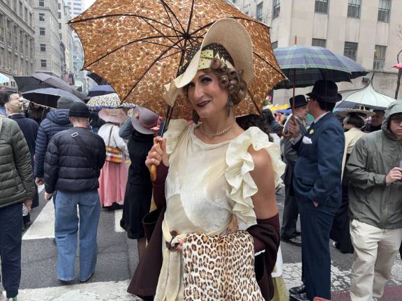 Adrienne Weidert came with an umbrellas but said she did not want to risk her straw bonnet if the rain was heavy.