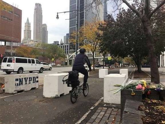 A cyclist passes temporary concrete barriers installed on the Hudson River Park Bikeway in Lower Manhattan following the Oct. 31 vehicle attack that killed eight people. Photo: Michael Garofalo