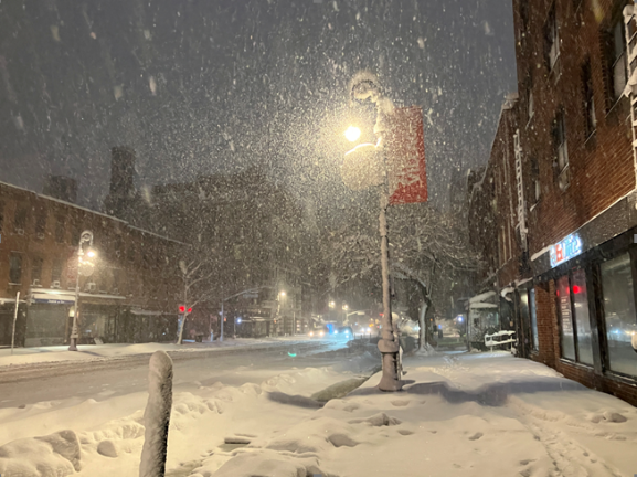 Sixth Ave. in Greenwich Village is virtually devoid of traffic on the evening of Feb. 22, as most motorists heeded the emergency ban to stay off streets from 9 p.m. until noon on Feb. 23.