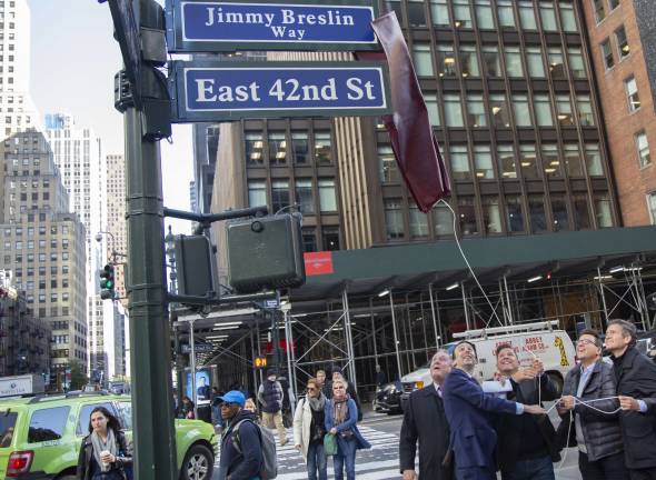 The newly renamed “Jimmy Breslin Way” is unveiled on 42nd Street on Oct. 17 in honor of the late Daily News columnist. Pulling the cord, from left to right, are Queens City Council Member Daniel Dromm, East Side Member Keith Powers, twin brothers James and Kevin Breslin and East Side state Sen. Brad Hoylman. Photo: New York City Council Photographer John McCarten