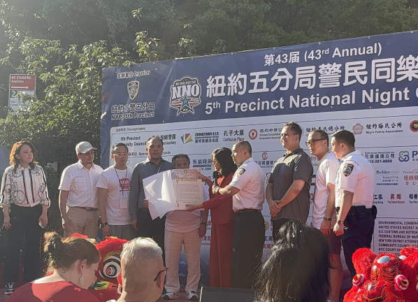 Deputy Mayor for Economic Justice Julie Su presents Commanding Officer Michael Lam with a proclamation on behalf of Mayor Mamdani.