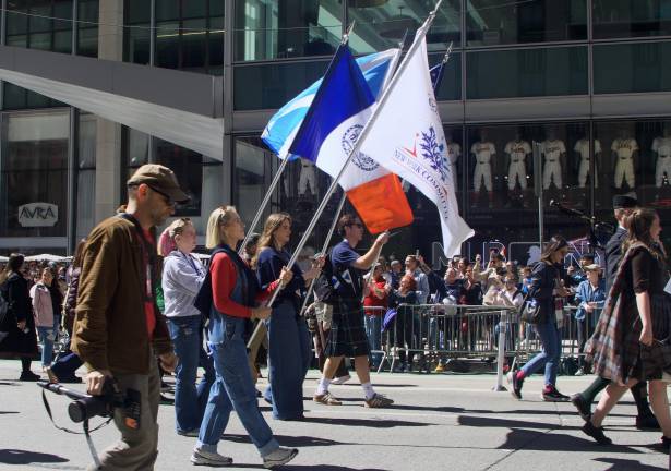 Tartan Day Parade marches up Sixth Avenue, plaid and pipers everywhere.
