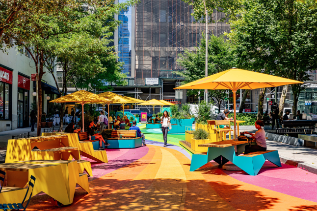 A new plaza has opened next to Spring Street Park in Hudson Square, complete with furniture and a vibrant mural. Free programming will be held at the park until October 29.