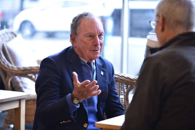 Just three days after returning to the Democratic Party, ex-Mayor Michael Bloomberg schmoozes with a potential voter on Oct. 13 in New Hampshire. Photo: Via Bloomberg's flickr page